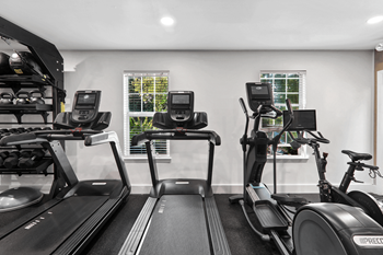 a gym with treadmills and exercise bikes at Caveness Farms Apartments, Wake Forest, NC 
